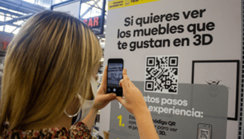 Foto de mujer enfocando con su celular un código QR